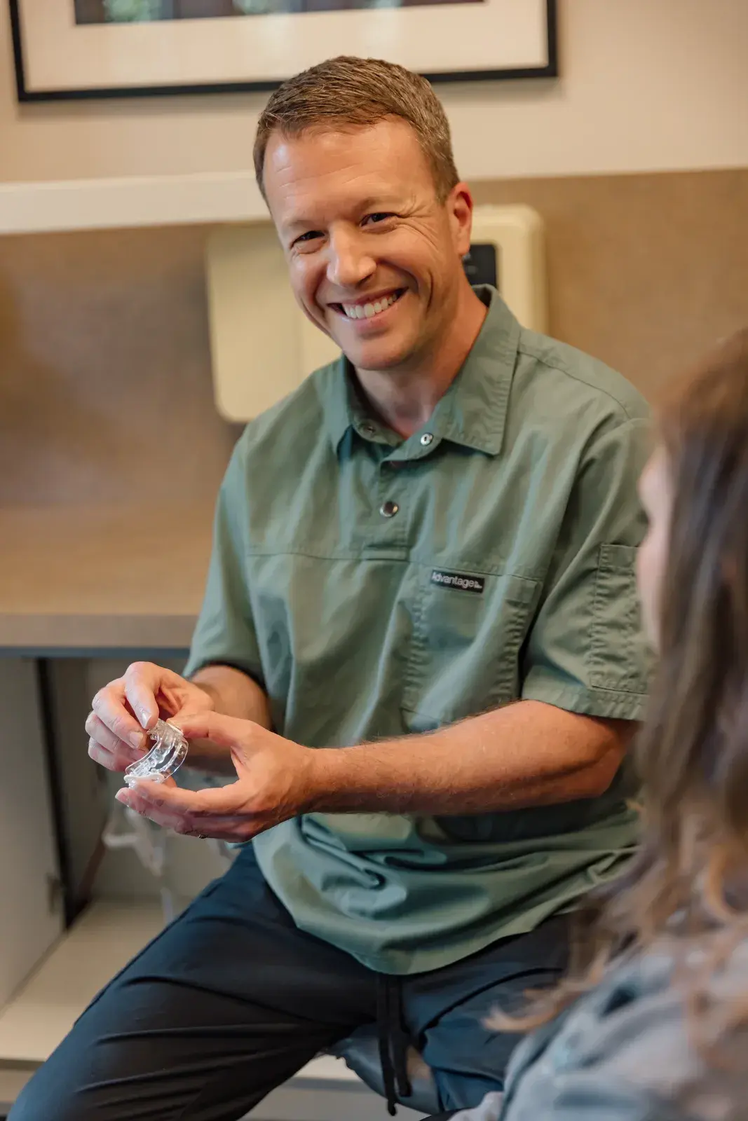 Dr. Lemperes holding a clear dental aligner